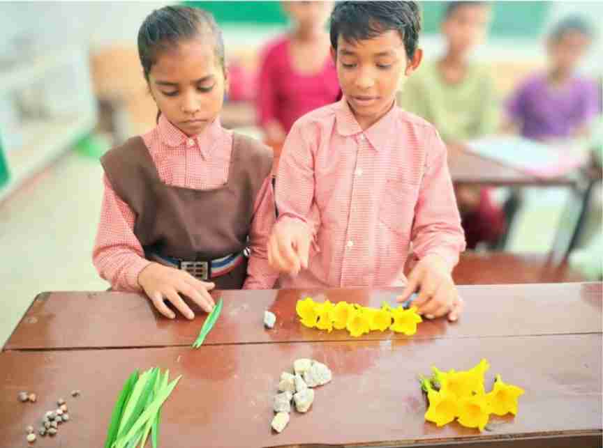 Children using locally available resources as counters for numeracy activities